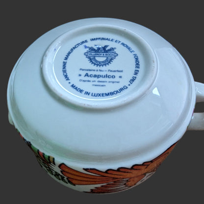 Original Stamp. Vintage Villeroy & Boch Acapulco creamer. This scented candle is poured into an authentic Villeroy & Boch Acapulco creamer, marked “Made in Luxembourg” and featuring the iconic blue dove motif. The Acapulco pattern was designed in 1967 by Christine Reuter, inspired by Mexican folk art. Its vibrant birds and flowers are applied to porcelain in the elegant “Milano” shape, created by Ludwig Scherer. 